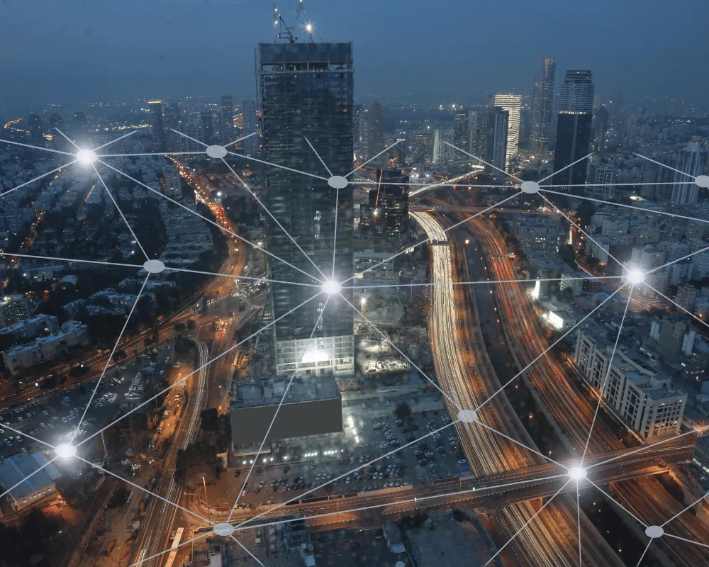 Sectors we serve: city at dusk with glowing network lines connecting buildings and roads